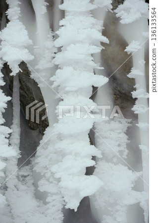 Delicate white ice formations grow along frozen surfaces at Lake Baikal, creating layered crystalline textures in winter conditions 136133564