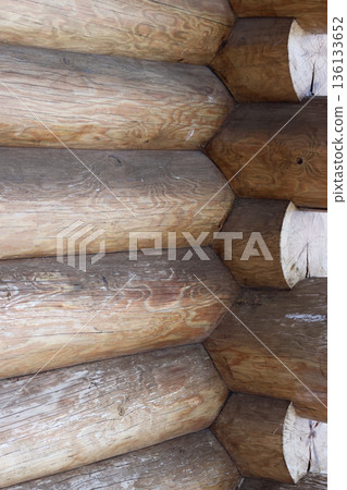 Fragment of a log cabin. New logs without bark. 136133652