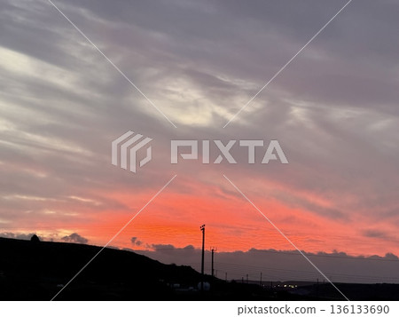 Dramatic sunset sky over rocky landscape. Sunset over rolling hills. 136133690