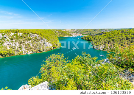 Higway over the Krka river, Croatia. View from famous bridge near the Sibenik and Skradin city. River with boat and yacht. Higway over the Krka river, Croatia. View from famous bridge near the Sibenik and Skradin city. River with boat and yacht. 136133859