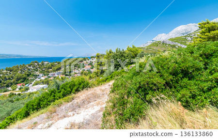 Baska Voda, Croatia - view of coast, sea and mountains. Famous travel destination. Baska Voda, Croatia - view of coast, sea and mountains. Famous travel destination. 136133860