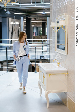 Woman exploring a luxury bathroom showroom interior Woman exploring a luxury bathroom showroom interior 136133866