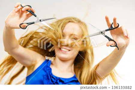 Girl with scissors for haircutting Girl with scissors for haircutting 136133882