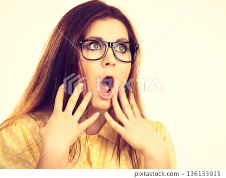 Shocked amazed woman gesturing with hands 136133915