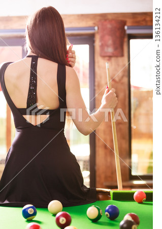Young woman posing having fun with billiard. Young woman posing having fun with billiard. 136134212