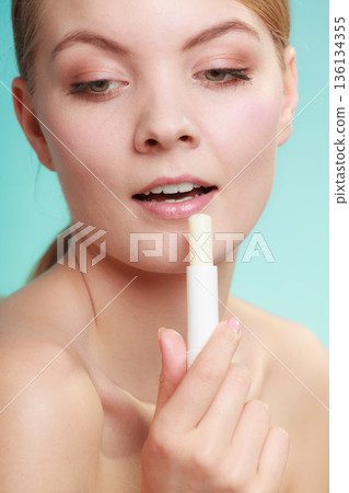 woman applying balsam for lips woman applying balsam for lips 136134355