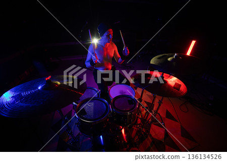 Drummer performing live on stage during concert Drummer performing live on stage during concert 136134526