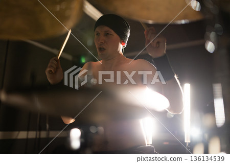 Male drummer actively playing acoustic drum kit live Male drummer actively playing acoustic drum kit live 136134539