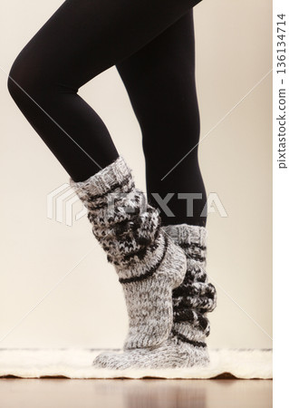 Woman legs wearing woolen socks and black tights Woman legs wearing woolen socks and black tights 136134714