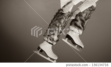 Woman legs wearing ice skates fur socks, skating Woman legs wearing ice skates fur socks, skating 136134716