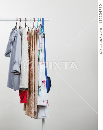 Clothes on hangers in closet 136134780