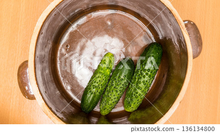 Making pickled cucumbers in clay jar Making pickled cucumbers in clay jar 136134800
