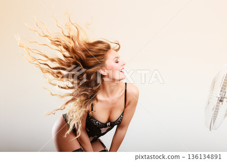 Woman with wind in hair Woman with wind in hair 136134891
