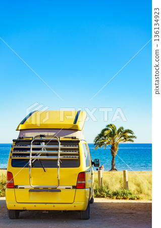 Camper van with tent on roof on beach 136134923
