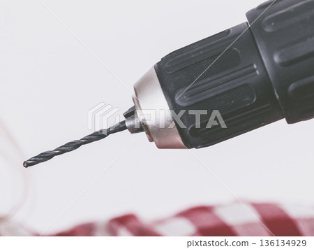 Person drilling in wall 136134929