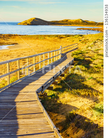 Beach with wooden path to sea water. Beach with wooden path to sea water. 136134938