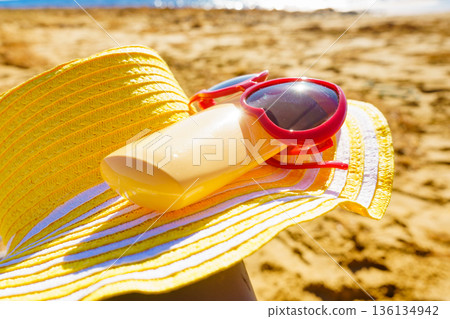 Sun protection gear on sand beach 136134942