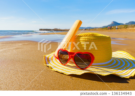 Sun protection gear on sand beach 136134943