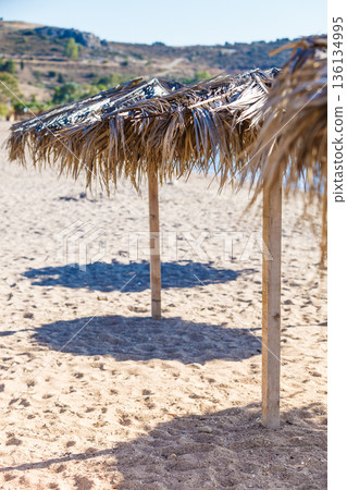 Sun parasols umbrellas on beach Sun parasols umbrellas on beach 136134995