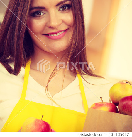 Woman housewife in kitchen with many fruits 136135017