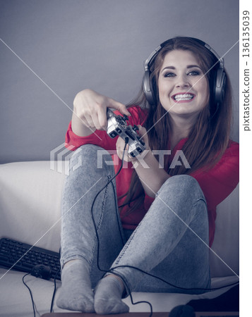 Young woman playing video games Young woman playing video games 136135039