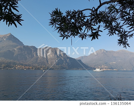 TREMEZZO, ITALY - Lake Como on a cloudy spring evening. TREMEZZO, ITALY - Lake Como on a cloudy spring evening. 136135064