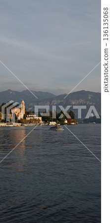TREMEZZO, ITALY - Lake Como on a cloudy spring evening. TREMEZZO, ITALY - Lake Como on a cloudy spring evening. 136135068