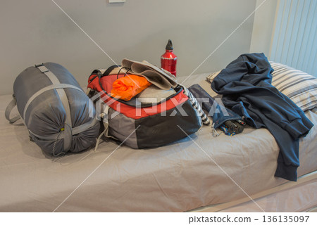 Bedroom of young person, preparing his backpack for camping Bedroom of young person, preparing his backpack for camping 136135097