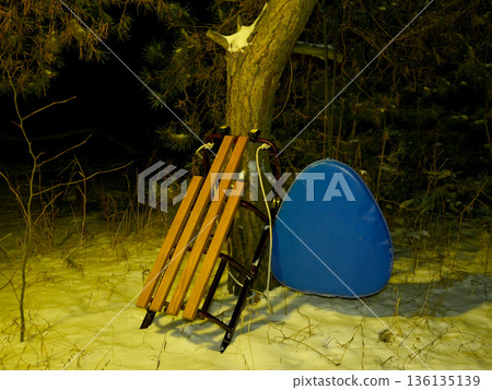 sled and snow tube by a tree sled and snow tube by a tree 136135139