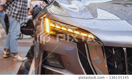 Car headlight and grille showcasing modern automotive design 136135145