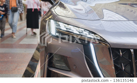 Modern car headlight illuminating urban Moscow street 136135146