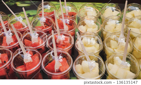 Fresh watermelon and melon fruit salad portions in clear plastic takeaway cups 136135147