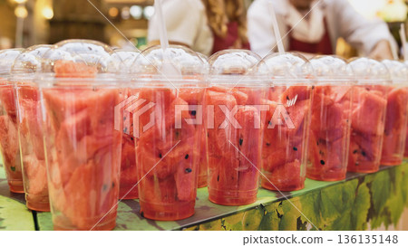 Watermelon cubes in plastic cups selling at market in Moscow Watermelon cubes in plastic cups selling at market in Moscow 136135148