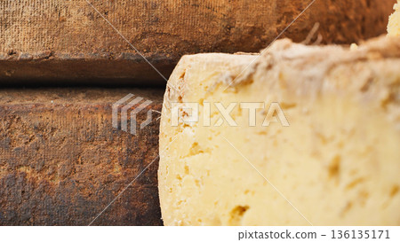 Artisan aged cheese wheel with rustic rind, traditional dairy food product Artisan aged cheese wheel with rustic rind, traditional dairy food product 136135171