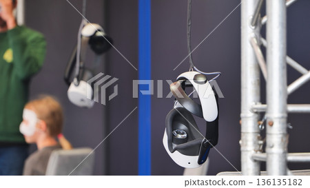 Virtual reality headsets hanging at gaming event 136135182