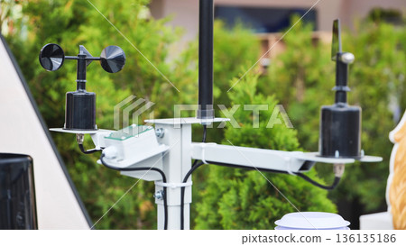 Weather station measuring wind speed and direction outdoors Weather station measuring wind speed and direction outdoors 136135186