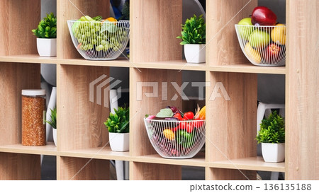 Wooden shelf displaying fresh fruit and decorative plants Wooden shelf displaying fresh fruit and decorative plants 136135188