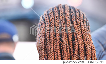 African-American woman showing long box braids hairstyle from back view African-American woman showing long box braids hairstyle from back view 136135198