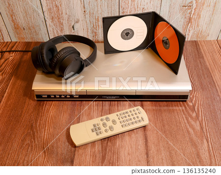 player with headphones and vertically standing discs 136135240