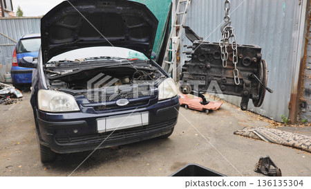 Removing old engine from car for repair, auto service and motor overhaul concept 136135304