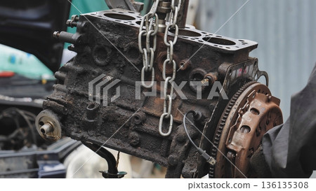 Mechanic repairing car engine at auto service station Mechanic repairing car engine at auto service station 136135308