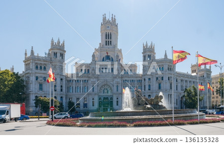 Palacio de Cibeles and fountain with Spanish flags in Madrid, Spain 136135328