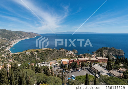 Panoramic view of Taormina coastline and Ionian Sea with Isola Bella, Sicily, Italy Panoramic view of Taormina coastline and Ionian Sea with Isola Bella, Sicily, Italy 136135329