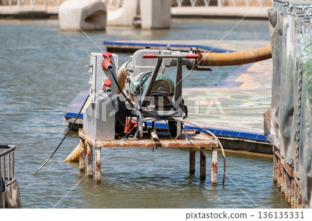 Portable drainage pump with electric motor on dock 136135331