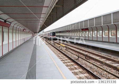 Vienna metro platform with modern train and long perspective 136135336