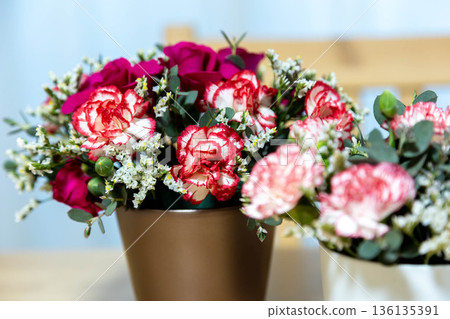 Colorful flower arrangement on the table Colorful flower arrangement on the table 136135391