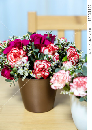 Colorful flower arrangement on the table 136135392