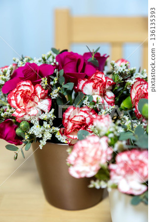 Colorful flower arrangement on the table Colorful flower arrangement on the table 136135393