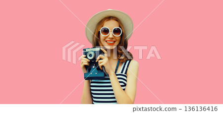 Portrait of happy young woman photographer with camera, girl taking a picture Portrait of happy young woman photographer with camera, girl taking a picture 136136416