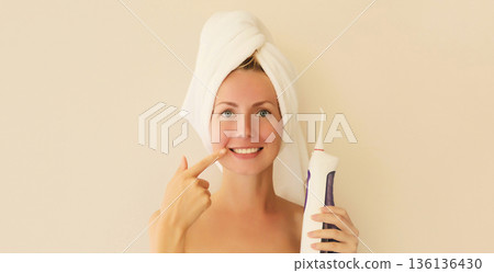 happy smiling young woman points to her clean white teeth happy smiling young woman points to her clean white teeth 136136430